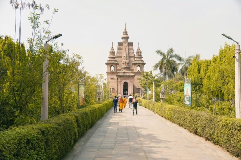 Ancient Sarnath Temple in Varanasi, India, with its grand stupa and lush green surroundings under a clear blue sky