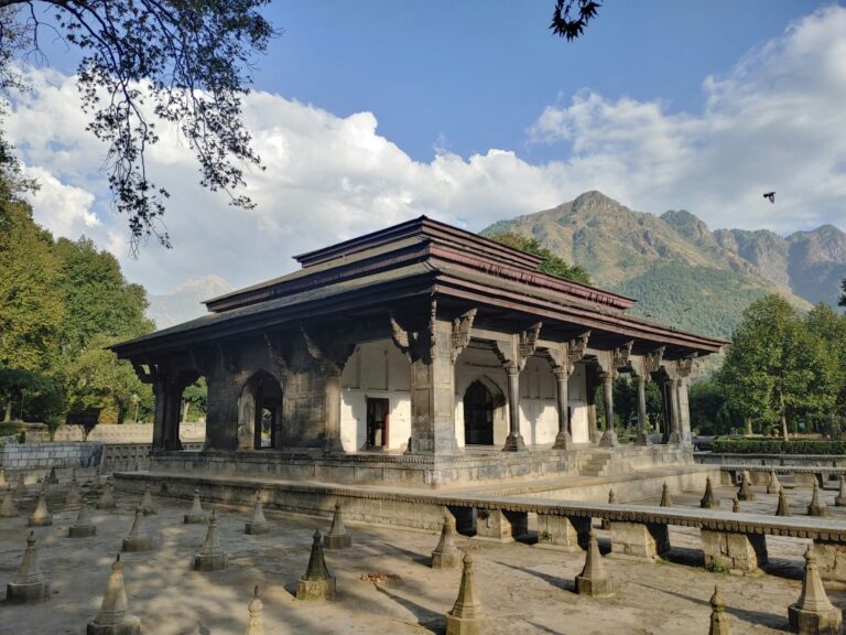 Beautiful Shalimar Bagh, a historic Mughal garden in Srinagar, featuring meticulously arranged flower beds, cascading fountains, and terraced landscapes surrounded by lush greenery and the majestic backdrop of the Himalayan mountains.