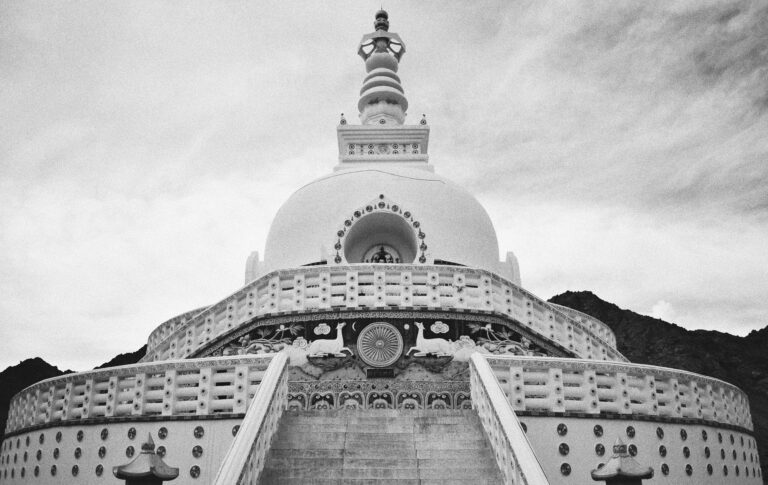 Shanti Stupa, a white-domed Buddhist monument standing tall on a hilltop in Leh, offering panoramic views of the surrounding mountains and city, especially beautiful at sunrise and sunset.