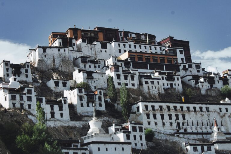 Majestic view of Thiksey Monastery, a multi-story Buddhist monastery resembling the Potala Palace, perched on a hilltop with panoramic views of the surrounding Leh Ladakh landscape