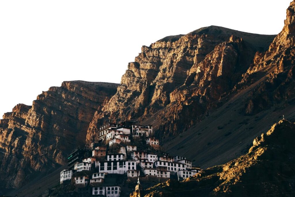 Key Monastery perched on rugged cliffs in Spiti Valley, Himachal Pradesh, with its white structures contrasting against the rocky mountains.